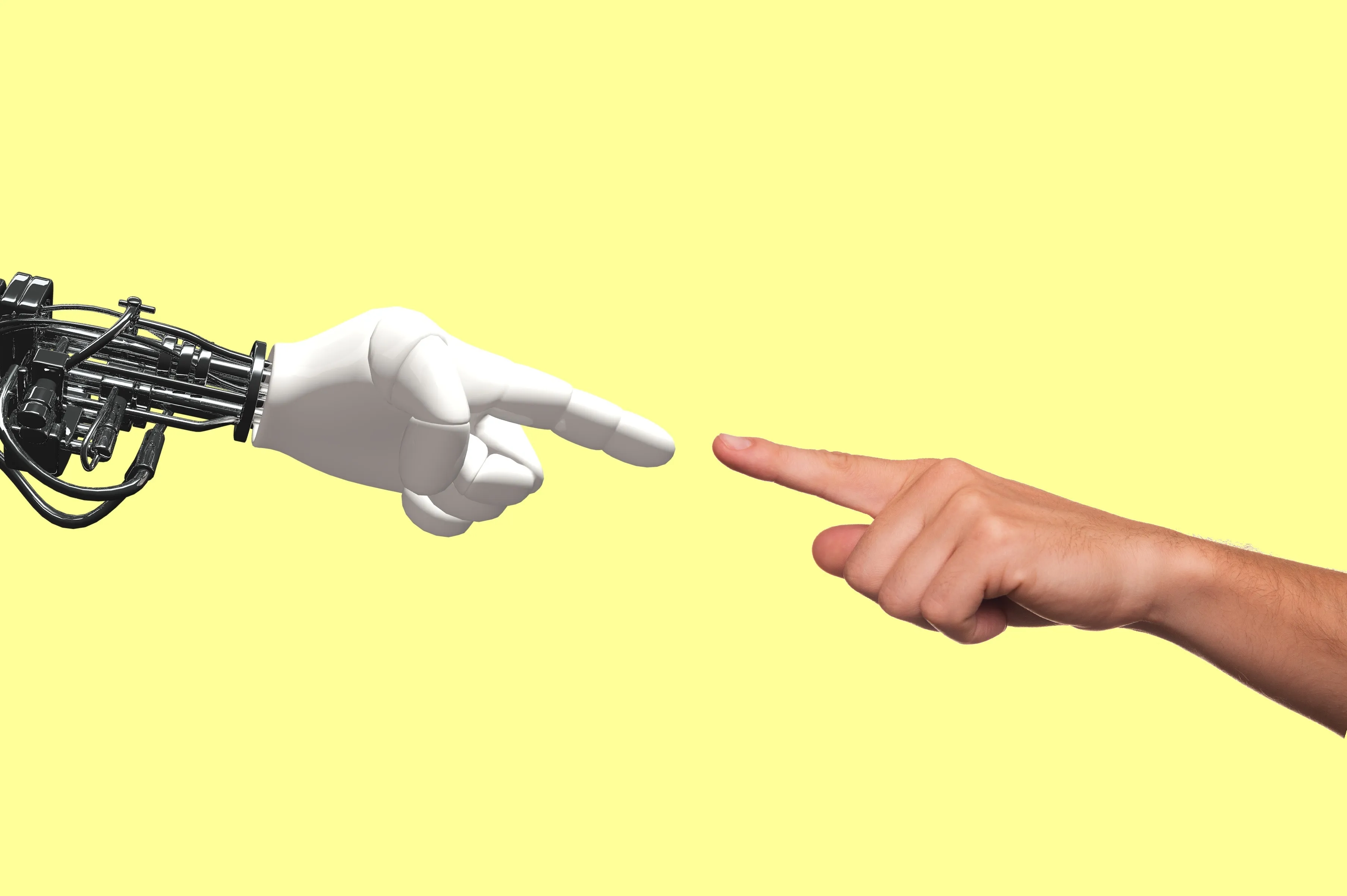 A robot hand and a human hand reaching toward each other, fingers nearly touching